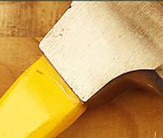 Zoomed In A yellow handle with a silver top Hammer
