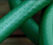 Zoomed In A green object that is tangled Hose