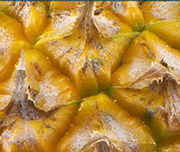 Zoomed In A fruit with a spikey-yellow skin on the outside Pineapple 