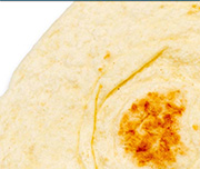 Zoomed In Apiece of food with a brown circle in the middle Tortilla 