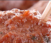 Zoomed In A piece of meat with sauce on it Meatball 