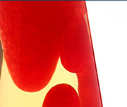 Zoomed In A lamp with a red blob of liquid in it Lavalamp
