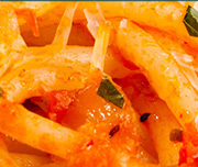 Zoomed In Yellow food with red sauce on it Pasta 