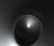 Zoomed In A black object with a round middle Speaker 