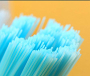 Zoomed In A yellow background with blue brush threads Toothbrush 